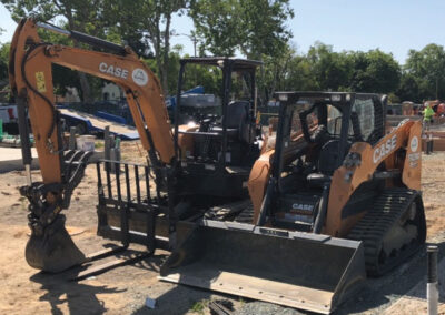 Backhoe and bulldozer equipment for plumbing trenches